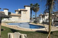 Townhouse with 2 bedrooms and 2 bathrooms in Orihuela Costa (Villas San Jose II), Alicante.

This charming townhouse offering a comfortable and stylish living space just a short distance from the vibrant heart of the area. Set on a generous 158 square meter plot, the property provides a perfect combination of privacy and outdoor enjoyment, ideal for those seeking a relaxed Mediterranean lifestyle.

Inside, the home features bright, well-proportioned rooms that create a seamless flow between indoor and outdoor living areas. The two bedrooms are spacious and inviting, complemented by two modern bathrooms designed for comfort and convenience. The living spaces are filled with natural light, enhancing the warm and welcoming atmosphere throughout the property.

Step outside to discover multiple outdoor areas, perfect for dining al fresco, entertaining guests, or simply basking in the Spanish sunshine. A notable highlight is the private solarium, an elevated space offering stunning views and ample room for sun loungers, outdoor seating, or even a summer kitchen—an ideal spot for enjoying warm evenings and sun-filled days.

Residents benefit from access to a well-maintained communal swimming pool, set within a peaceful, private street that enhances the sense of tranquility and exclusivity. The property also includes off-road parking, providing added convenience.

Located just a ten-minute walk from the lively Cabo Roig Strip, the property is close to an array of restaurants, bars, and entertainment options. The stunning beaches, local amenities, and excellent transport links are also nearby, making this an excellent choice whether as a permanent residence, holiday retreat, or investment opportunity.

Built in 2002, the property features air conditioning for comfort and offers a total build size of 85 square meters. Its northeast orientation ensures plenty of natural light, creating a bright and airy living environment in one of the most desirable areas on the Costa Blanca.

Bedrooms: 2
Bathrooms: 2
Build Size: 85 m2
Plot: 158 m2
Orientation: Northeast
Year of construction: 2002

Air conditioning
Communal pool
Private solarium
Terrace
Off road parking