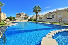 Semi detached with 3 bedrooms and 2 bathrooms in Orihuela Costa (Jumilla, Playa Flamenca), Alicante.

Discover this charming semi-detached home in Orihuela Costa, situated in the sought-after community of Jumilla, Playa Flamenca, Alicante. Featuring three spacious bedrooms and two modern bathrooms, this property offers a perfect blend of comfort and outdoor living. Set on a rare, large corner plot within a secure gated community, it boasts extensive wraparound gardens ideal for entertaining, sunbathing, or enjoying the Mediterranean climate. The property includes off-road parking, ensuring convenience and privacy.

The interior showcases a bright lounge with a cozy fireplace, a well-equipped kitchen, and two double bedrooms with fitted wardrobes on the ground floor. Upstairs, you’ll find a twin bedroom, a second bathroom, and access to a generous private balcony, perfect for relaxing and soaking up the sunshine. The home is fully furnished with air conditioning, white goods, ceiling fans, and stylish fixtures, ready for immediate move-in.

Located just a short walk from vibrant bars, restaurants, and amenities of La Florida and Playa Flamenca, this residence provides easy access to stunning beaches, Zenia Boulevard shopping center, golf courses including Villamartin, Campoamor, and Las Ramblas, and excellent transport links. The community features a beautiful communal pool and well-maintained gardens, creating a peaceful and secure environment. With properties of this size and location rarely available, early viewing is highly recommended to secure this exceptional opportunity.

SUMA/IBI: 225€/Yearly
Community fees: 65€/Montly

Bedrooms: 3
Bathrooms: 2
Build Size: 90 m2
Orientation: Northeast
Year of construction: 2001

Air conditioning
Furnished
Private garden
Store room
White goods
Terrace
Fireplace
Communal garden
Ceiling fans
Gated community
Fitted wardrobes
Balcony
Walking to zenia boulevard